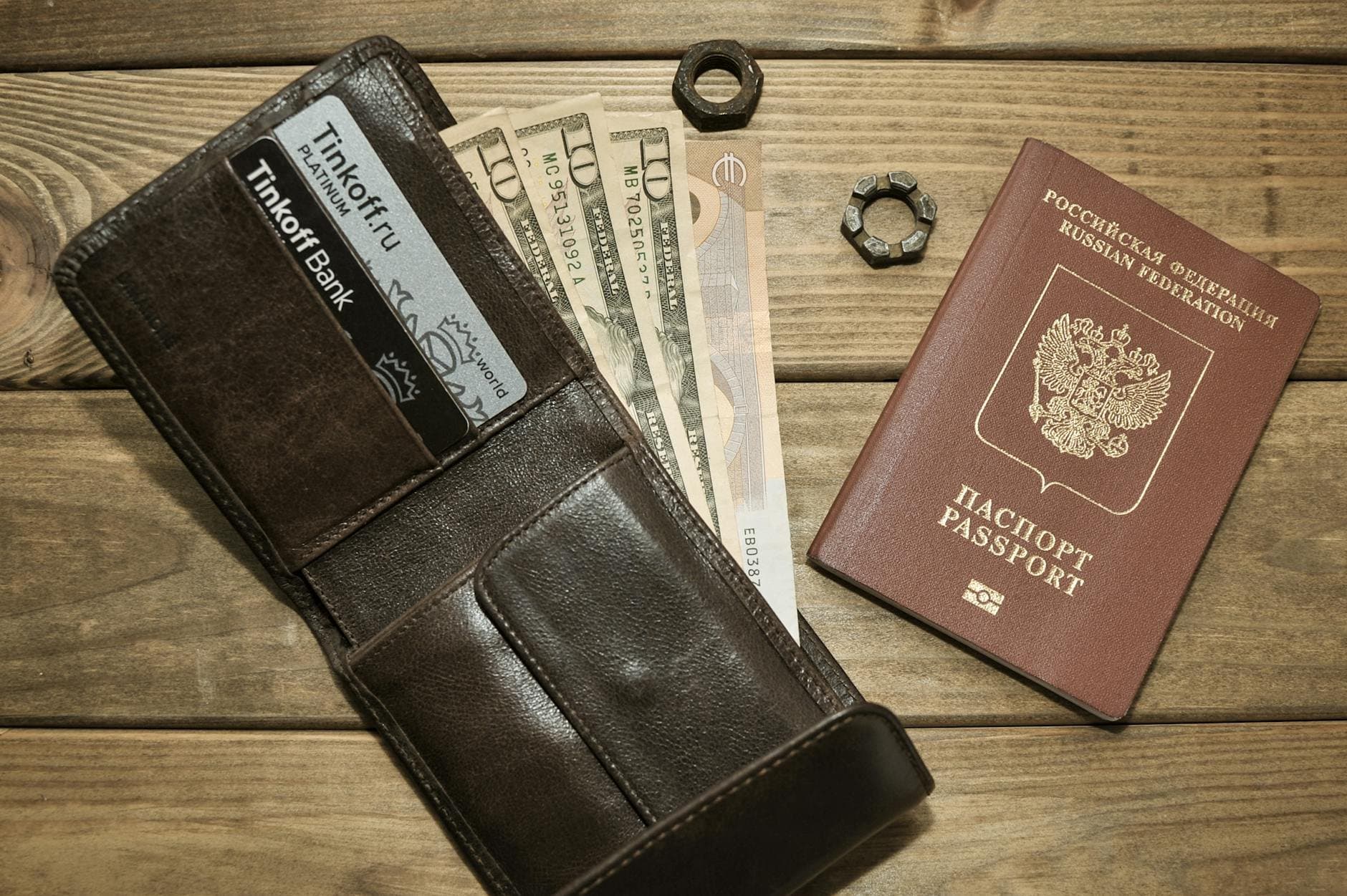 passport and bank card on wooden desk (Pexels)